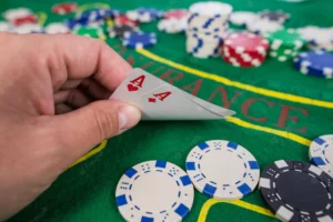 player-shows-two-play-card-aces-green-table-casino-with-chips-gambling_357889-3640
